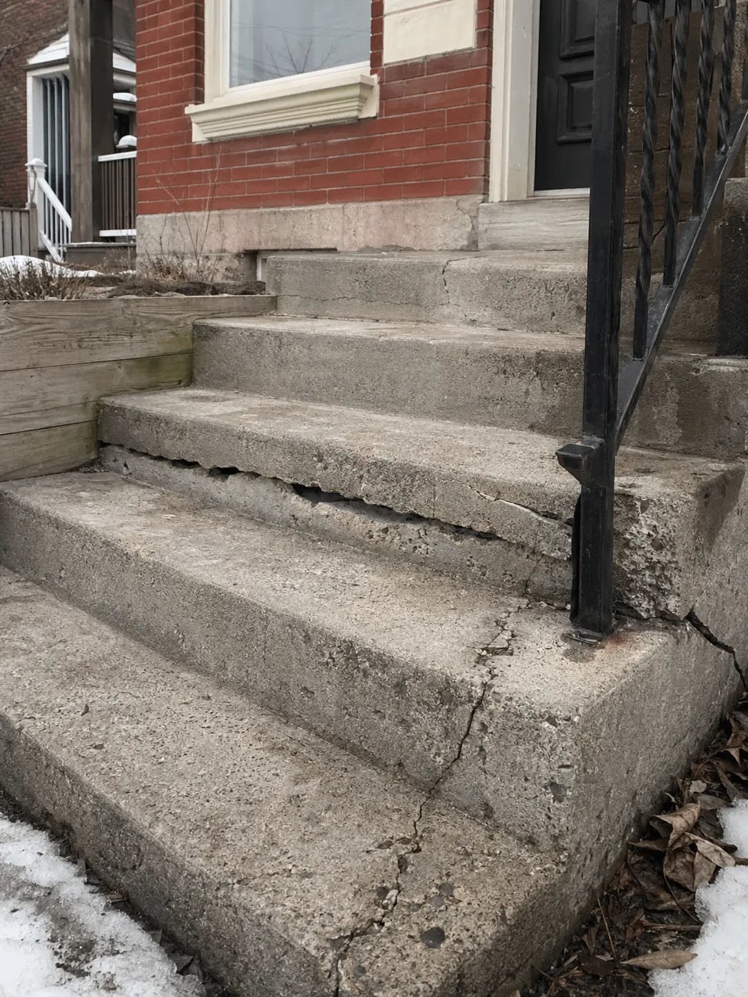 Cracked and sunken concrete front steps on a Toronto-area home
